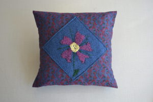 Purple flower pillow by Juvenia Nicodemos