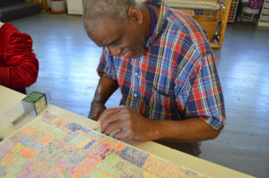 Sidney Perry working on a drawing on clay board in 2014.