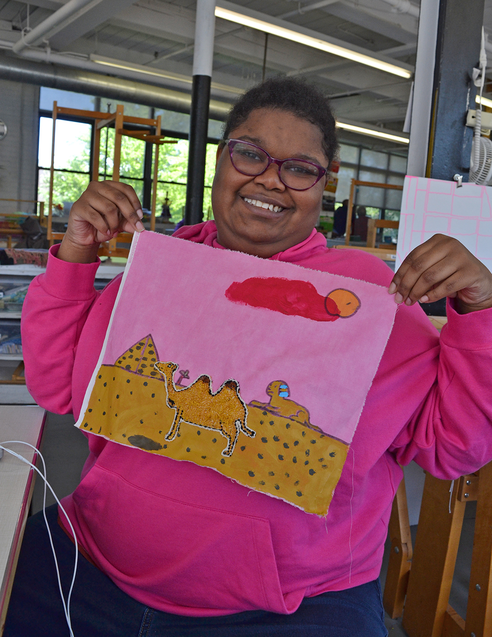 Jamilah Monroe showing off her artwork